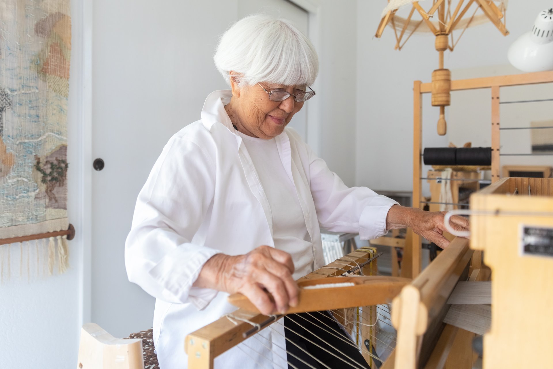 A fiber artist's loom with woven textile in progress
